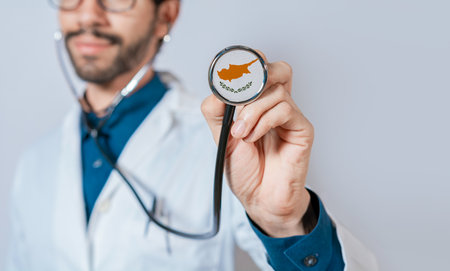 Doctor holding stethoscope with Cyprus flag. Cyprus health and care concept, Cyprus flag on stethoscopeの写真素材