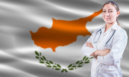 Female doctor on Cyprus flag. Doctor with crossed arms on Cyprus flag. Cyprus health and care conceptの写真素材