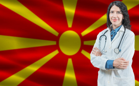Macedonian medicine and healthcare concept. Doctor close up against North Macedonia flag backgroundの写真素材