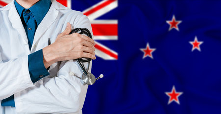 Doctor with stethoscope on New Zealand flag. Doctor holding stethoscope on New Zealand flagの写真素材