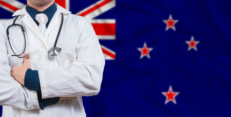 Male doctor with stethoscope on New Zealand flag. Doctor holding stethoscope on New Zealand flagの写真素材