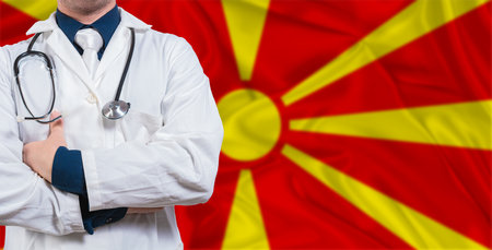 Male doctor with stethoscope on North Macedonia flag. Doctor holding stethoscope on North Macedonia flagの写真素材