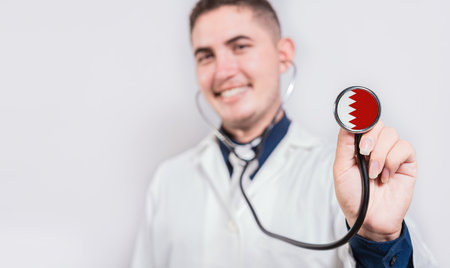 Doctor showing stethoscope with Bahrain flag. Bahrain national healthcare conceptの写真素材