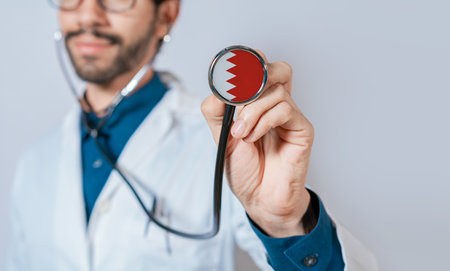 Doctor holding stethoscope with Bahrain flag. Bahrain health and care concept, Bahrain flag on stethoscopeの写真素材