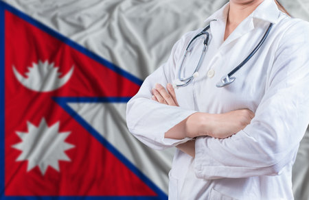 Doctor with crossed arms on Nepal flag. Nepali health and care concept. Female doctor on Nepal flagの写真素材