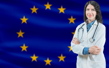 European Union medicine and healthcare concept Doctor close up against European Union flag backgroundの写真素材