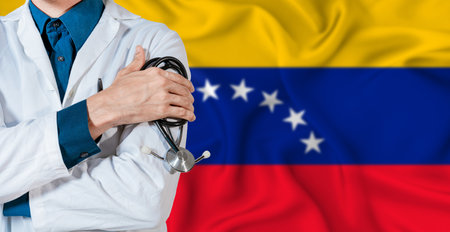 Venezuela healthcare concept. Doctor with stethoscope on Venezuela flag. Doctor holding stethoscope on Venezuelan flagの写真素材