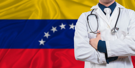 Male doctor with stethoscope on Venezuela flag. Doctor holding stethoscope on Venezuela flagの写真素材