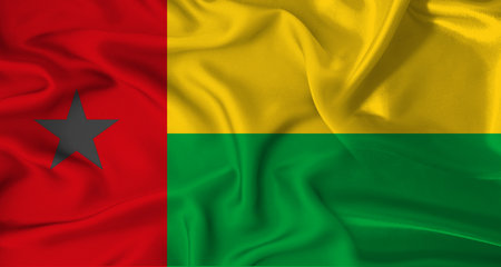 Realistic Guinea Bissau flag waving. Close up of flag of Guinea Bissau with cloth textureの写真素材