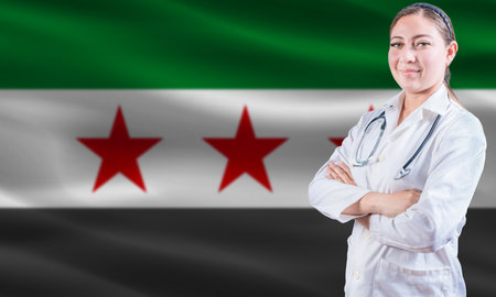 Female doctor on Syria flag. Doctor with crossed arms on Syria flag. Syria health and care conceptの写真素材