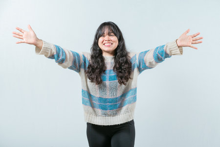 Beautiful asian woman welcoming you with open arms. Friendly asian girl welcoming with open arms isolatedの写真素材