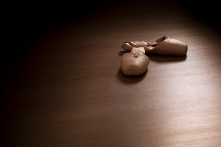 Pointe shoes on wooden floor の写真素材