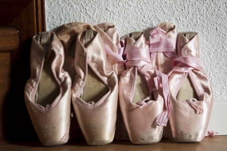 Group of pointe shoes leaned against the wall 