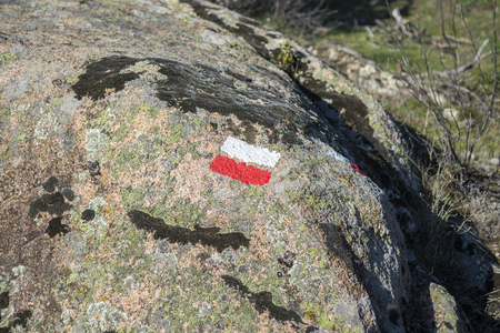 White and red marks of a Long Distance Walking Route (GR) on a granitic rock. Photo taken in La Pedriza, Guadarrama Mountains National Park, Madrid, Spainの写真素材
