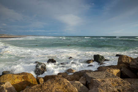 COSTA DA CAPARICA, PORTUGAL - APRIL 17, 2019: Surfing in the Costa da Caparica Beach, a famous place for water sports in Portugal.のeditorial素材