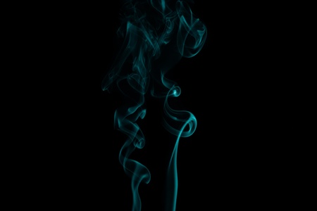 abstract forms created with blue smoke isolated backgroundの写真素材