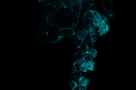 abstract forms created with blue smoke isolated backgroundの写真素材