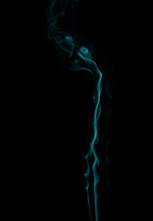 abstract forms created with blue smoke isolated backgroundの写真素材
