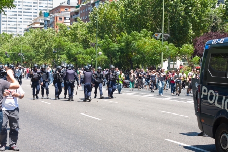 riot policemen against protesters prepared in a strike in Madridのeditorial素材