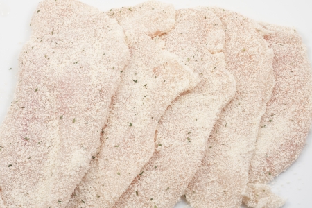 several breaded steaks isolated on white backgroundの写真素材