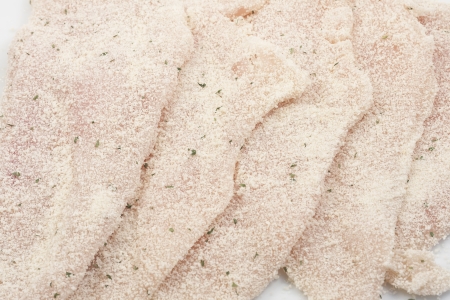 several breaded steaks isolated on white background