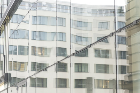 glass wall of office building with reflectの写真素材