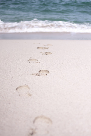 Traces of people in the sand of a beachの写真素材