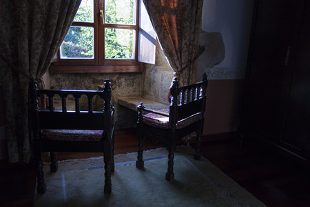 rustic chairs in front of a windowの写真素材