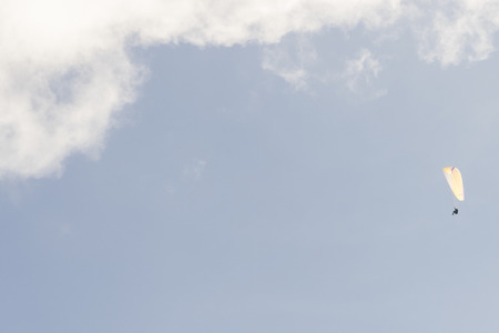 Paragliding in the blue sky with cloudsの写真素材
