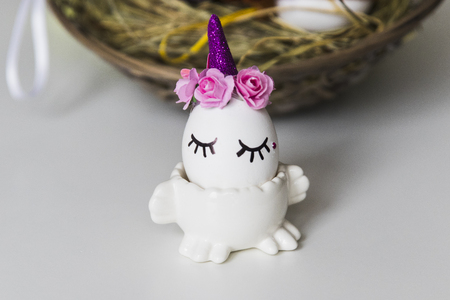 several Easter eggs on wicker basket with hayの写真素材