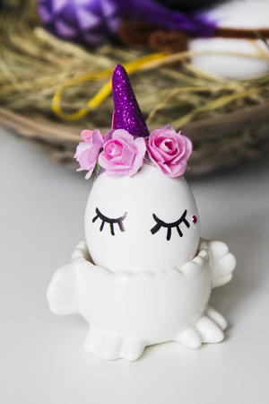 several Easter eggs on wicker basket with hayの写真素材