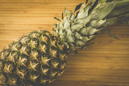 A pineapple close-up on wooden backgroundの写真素材