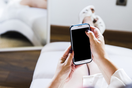 Hands using a smart phone in outdoorの写真素材