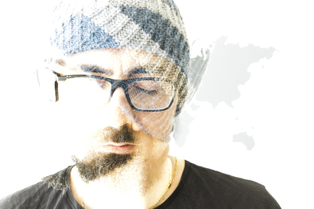 Young bearded man on white background with world map
