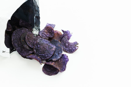 A Heap of purple potato chips on white backgroundの写真素材