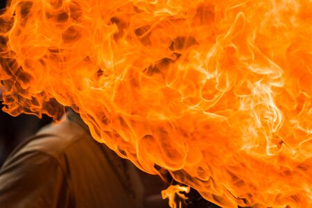 A Fire show artist breathe fire in the dark jamp