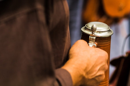 A man hand holding beer mug with lidの写真素材