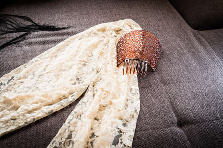 A typical spanish mantilla and comb on sofaの写真素材