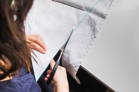 A woman's hands using sewing scissorsの写真素材