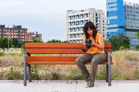 A young girl taking photograph with reflex cameraの写真素材