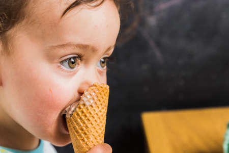 A baby eating an ice creamの写真素材