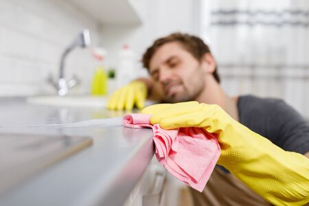 Close-up of Young Lad Wiping Kitchen Table