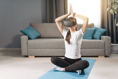 Athletic Woman Sitting in Padmasana With VR Headset on