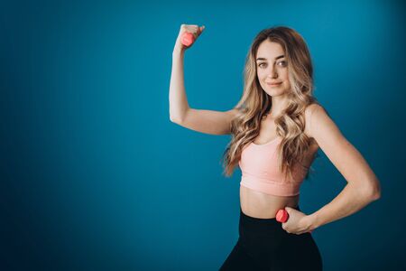 Charming girl showing her muscular body in studioの写真素材