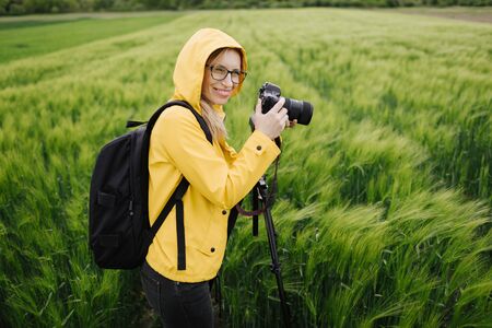 Cheerful photographer shooting wheat field