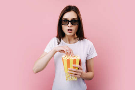 Woman in glasses 3d feeling surprised while watching movie