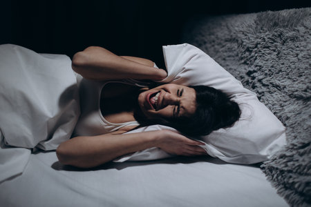 Stressed woman in bedの写真素材