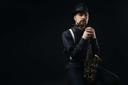 Artist posing with saxophoneの写真素材