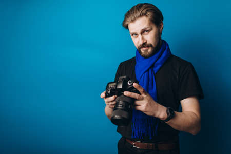 Bearded photographer using cameraの写真素材
