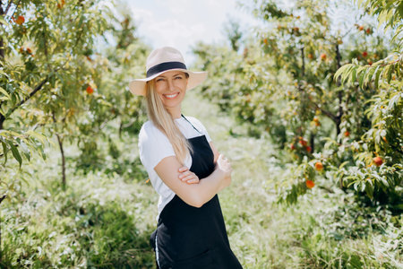 Woman posing on peach plantationの写真素材
